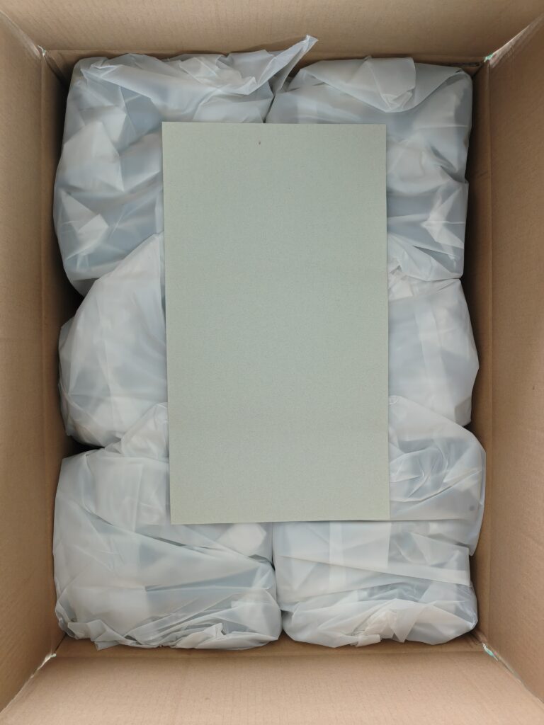 Custom handbag packing inspection with individual protective wrapping inside export carton.