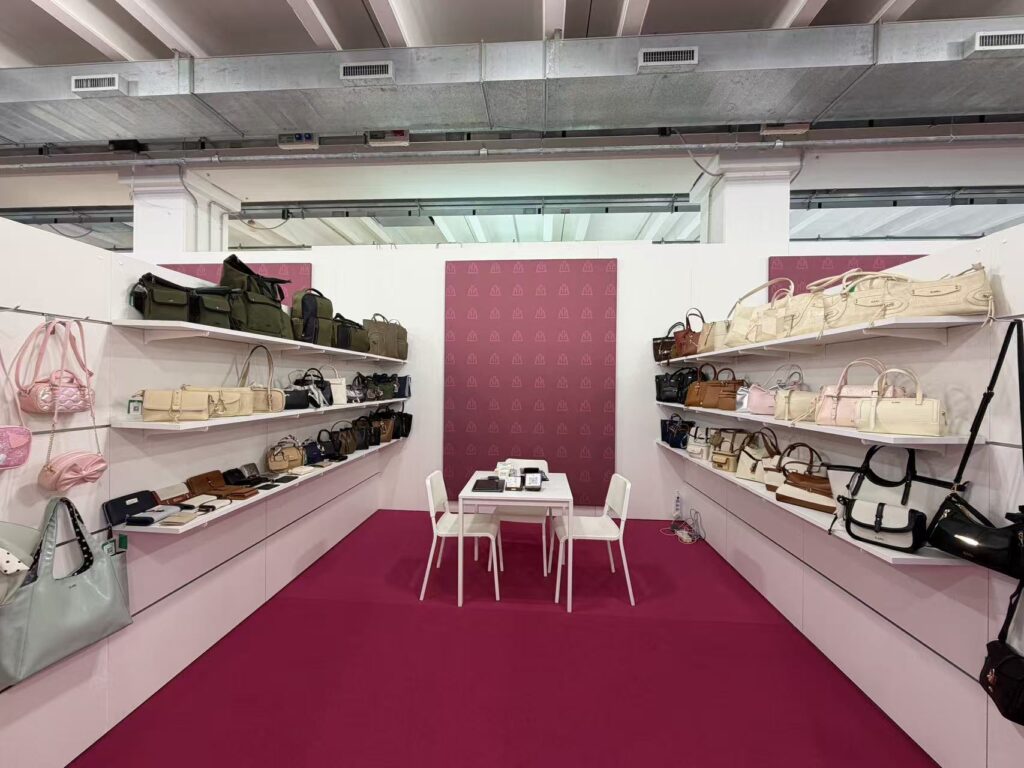Guangzhou S.MU Accessory Co Ltd booth B2B16 at Expo Riva Schuh and Gardabags Italy with handbag and accessory display.